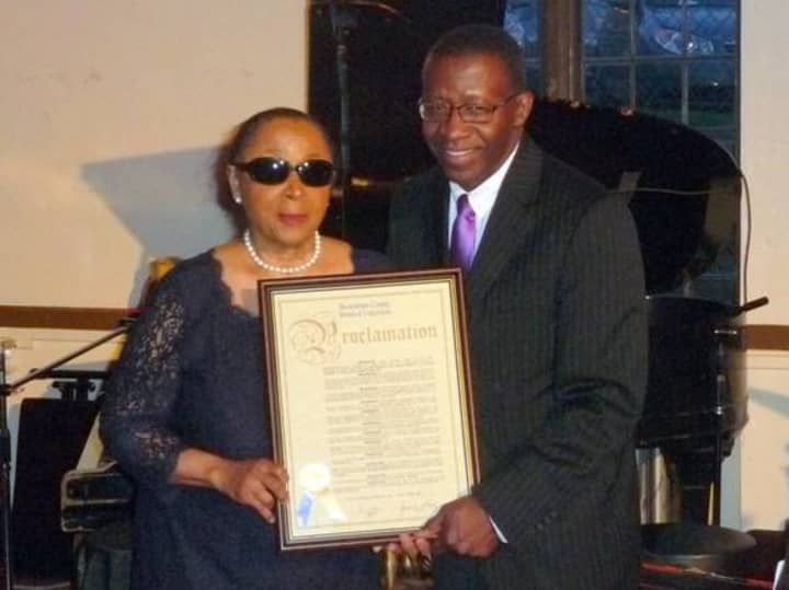 Dr. Valerie Capers receives her proclamation from Mount Vernon politician Lyndon Williams.
