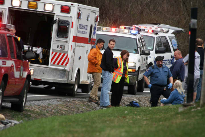 The North Salem Police, Croton Falls Fire Department and North Salem Volunteer Ambulance Corps help a woman on June Road.