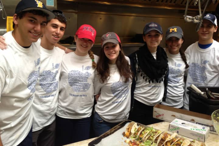 From left, Conservative Synagogue congregants Jared Weisman, Andrew Cohen, Danielle Frost, Annie Cooperstone, Jessica Felton, Perri Cohen and Matthew Hodes volunteer to serve food at the Norwalk Emergency Shelter on April 7.