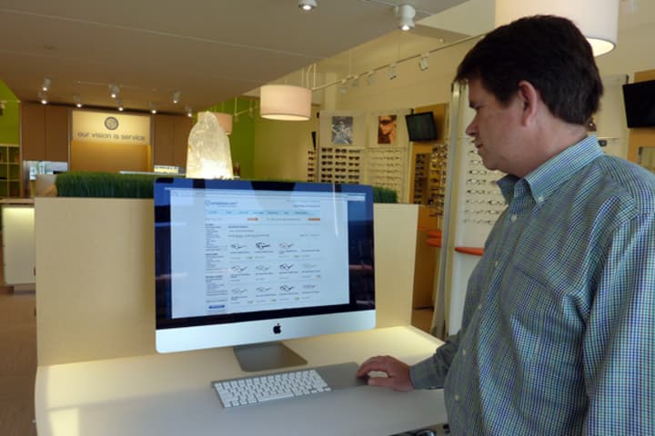 Westport resident Mark Agnew, owner of Eyeglasses.com, which opened its first retail store in Westport recently, shows off the store&#x27;s virtual inventory.