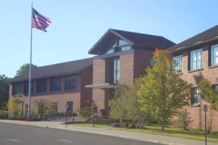 Two Darien High School students were charged with making a drug deal on school grounds.
