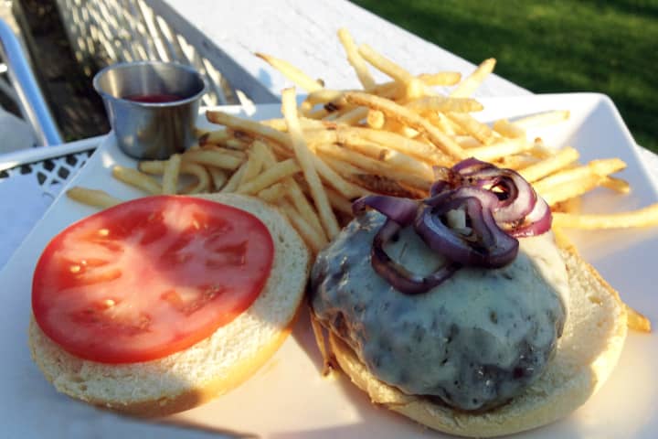 North Salem&#x27;s Vox burger is served on a brioche roll with grilled red onion, gruyere cheese, tomato and french fries.