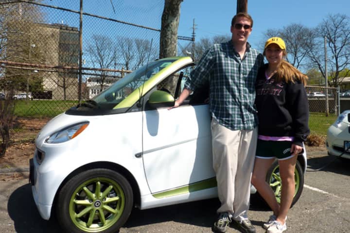 Norwalk resident Kyle Smith and Alyssa Esposito of Shelton show off the 2nd generation Smart Car they drove Saturday in Westport&#x27;s first electric car rally and showcase.