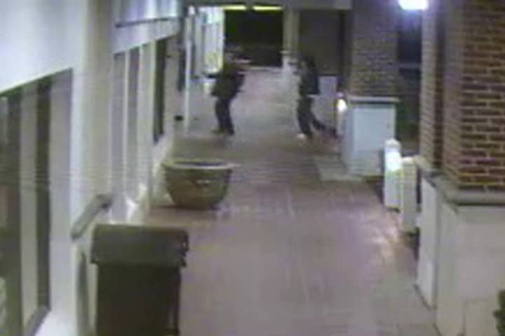 One of the suspects forces an employee to open Fairfield&#x27;s Lenox Jewelers during a robbery in April 2013.