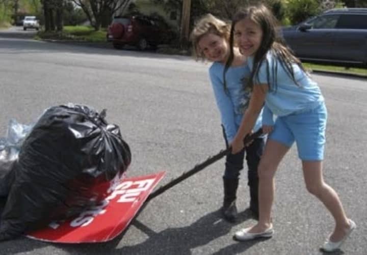 Residents pick up trash for the fifth annual Village Cleanup Day.