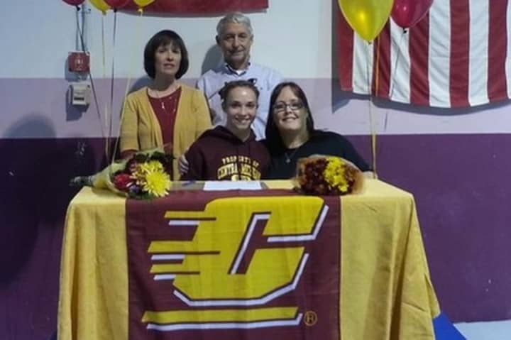 Caroline Fitzpatrick, front row, left, was joined by her parents and Arena Gymnastics coach Laurie Defrancesco when she signed her letter of intent to attend Central Michigan earlier this year.