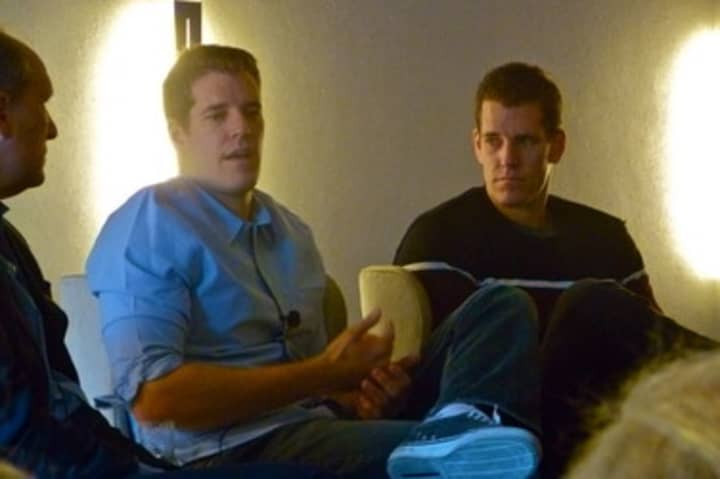 Entrepreneurs Tyler, left, and Cameron Winklevoss speak to a group of businesspeople at a lecture in Greenwich on Thursday.