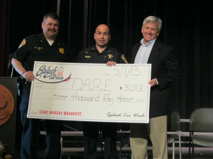 Bedford Detective Bill Smith, left, is joined by Bedford Detective Joe Comunale, and Splash Car Wash CEO Mark Curtis.