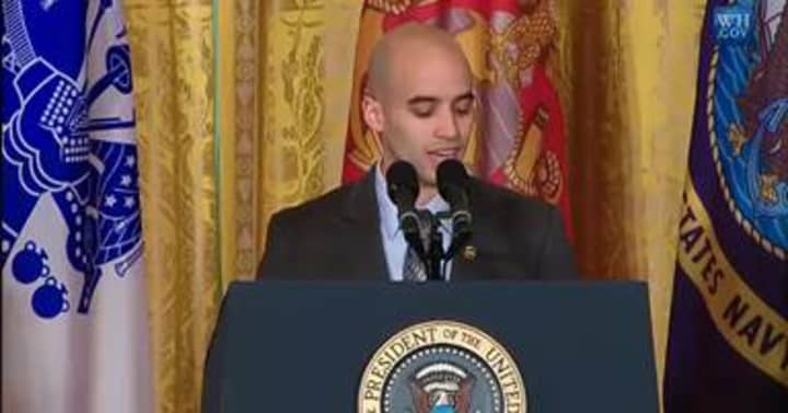 Mercy College graduate student David Padilla of the Bronx introduces President Obama at a White House event for veterans.