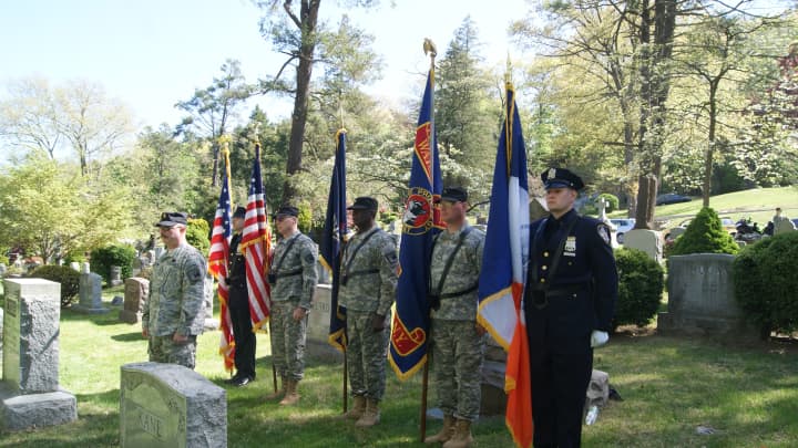 New York Guard Soldiers, Staff Sgt. Augustin L. DePalma, Staff Sergeant Louis DiGiannantonio, Specialist Carson W. Thompson, and Private Robert L. Freeman flanked by New York DEP Police officers, form a color guard during a memorial ceremony.