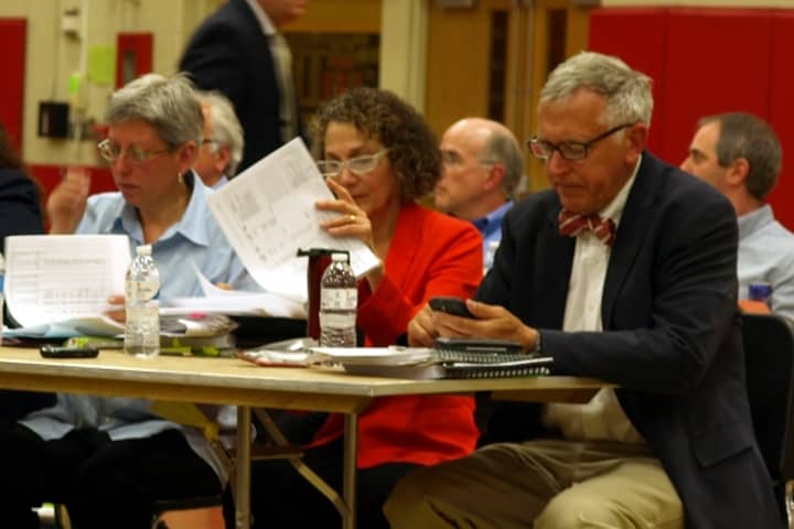 Members of Fairfield&#x27;s Representative Town Meeting look over the town&#x27;s budget before their vote Monday night.
