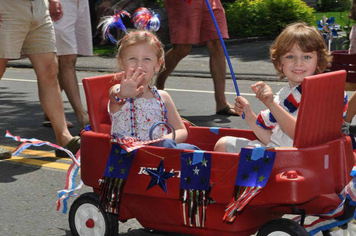 Kids enjoy a summer parade in Rowayton, which has been named the sixth happiest seaside town in America by Coastal Living magazine. 