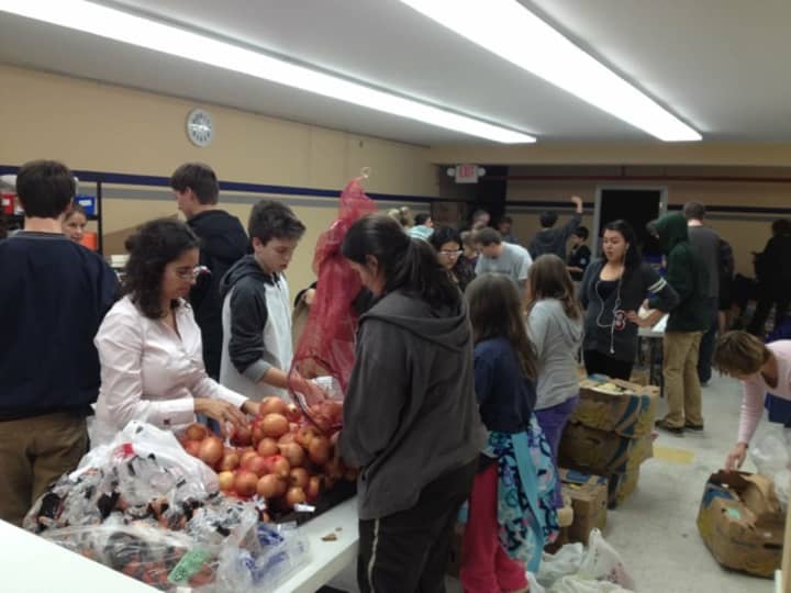 Larchmont Mamaroneck Hunger Task Force volunteers pack donated food items.