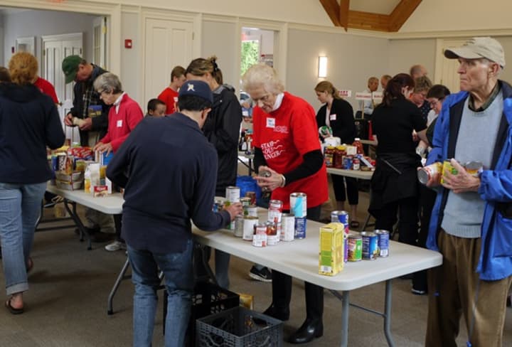 Nearly 100 volunteers helped to sort through the bags of food that was donated for the postal service food drive, &quot;Stamp Out Hunger.&quot; The National Association of Letter Carriers’ 24th annual &quot;Stamp Out Hunger&quot; food drive is Saturday in Greenwich.
