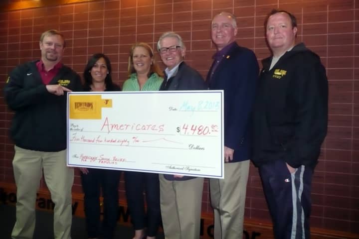 Representatives from the Wilton Y Wahoo Swim Team present AmeriCares President and CEO Curt Welling (3rd from right) with a check for $4,480. See story for full IDs.