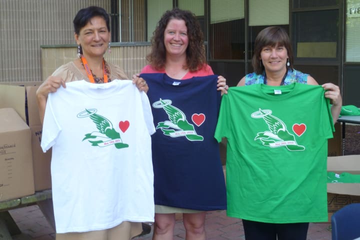 Rogers Park Middle School staff members (from left) Pat Joaquim, Jen Powers and Tracey Kurjiaka show t-shirts that will be given to runners and walkers at Saturday&#x27;s 5k in Danbury.