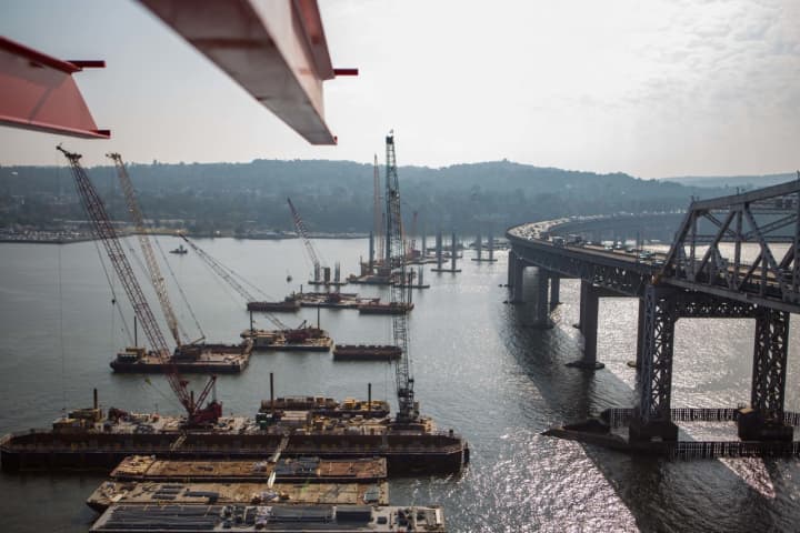 A former tugboat worker is suing the contractors working on the new Tappan Zee Bridge, claiming that he suffered paralyzing spinal injuries after being ordered to secure a barge during a storm last year.