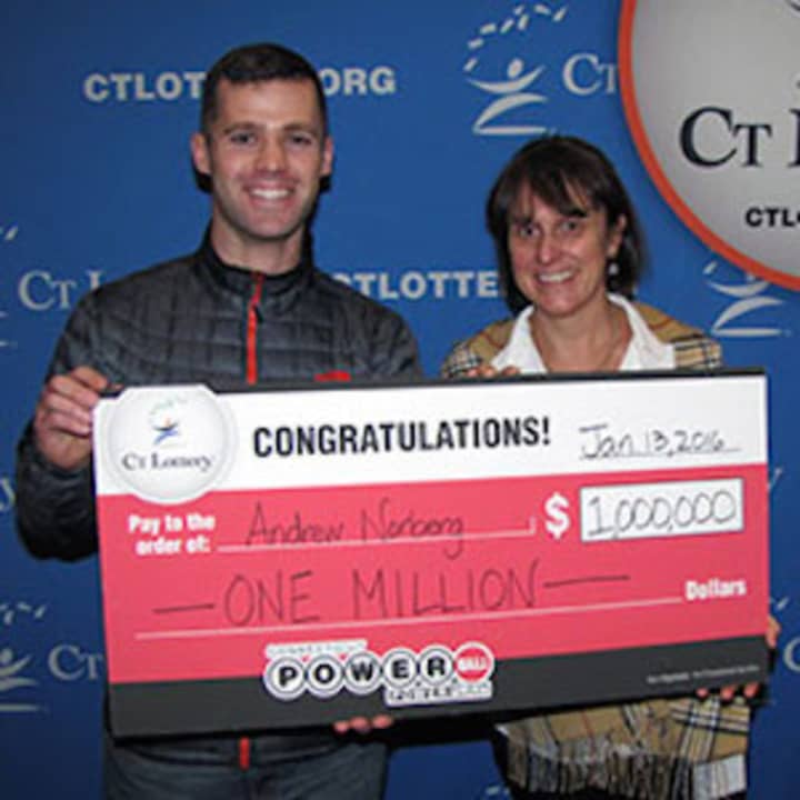 Lt. Andrew Norberg receives his $1 million check from Anne Noble, CT Lottery President and CEO for matching five numbers in the record Powerball drawing last week.