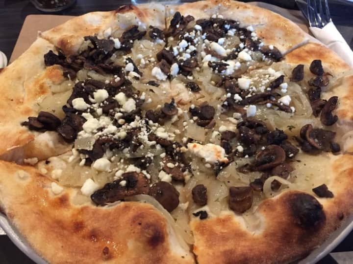 Funghi E Cipolle (sauteed mushrooms, caramelized onions over goat cheese with honey truffle oil and fresh thyme) pizza from Pizza E Birra (287 NY-211 in Middletown)