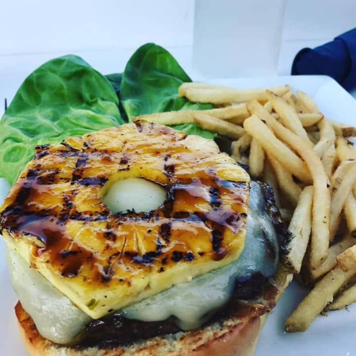 The glazed Island Burger with Angus chuck, jack cheese, lettuce, grilled pineapple and pineapple aioli from RUMBA (43 Canoe Place Road in Hampton Bays)