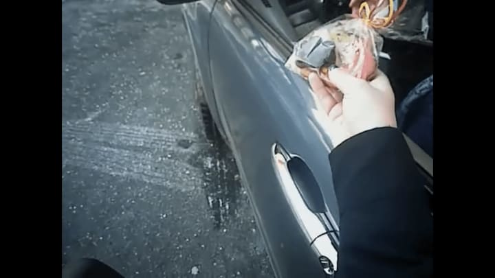 An Ossining police officer hands out cookies to a motorist rather than a ticket.