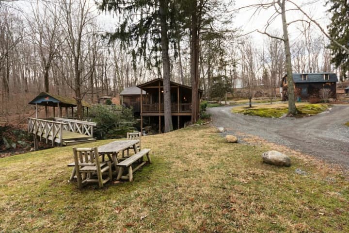 The Mill House property for sale in Wilton includes a main house — a converted saw mill house — as well as a cottage and carriage house.