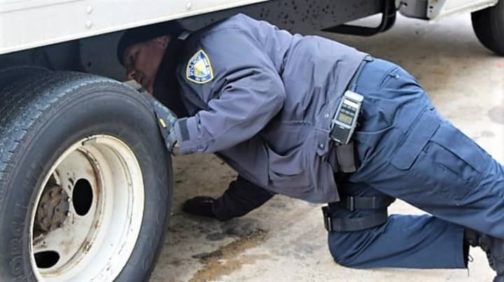 PAPD CVI Francis Franco inspecting a commercial vehicle.
