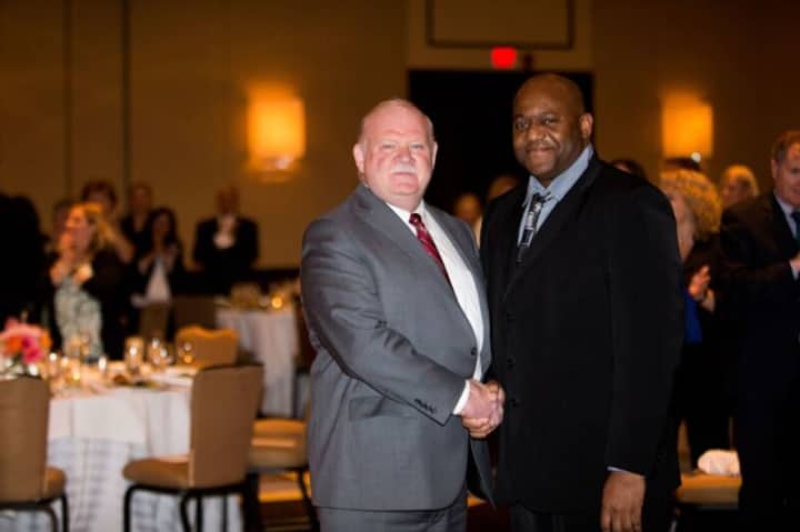 Marian Nowak Award winner Paul Pryce (right) congratulated by Norman Roth, Greenwich Hospital president, at the Employee Service Awards Dinner held on May 12 at the Greenwich Hyatt.