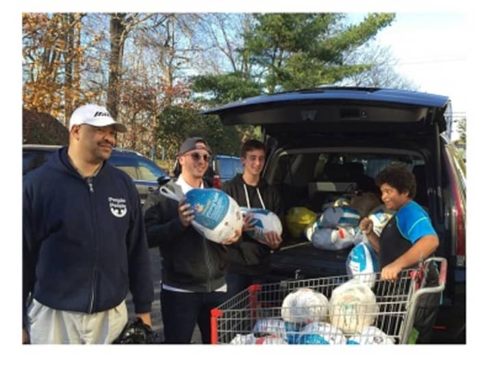 People to People volunteers collect frozen turkeys for the Nanuet food bank.