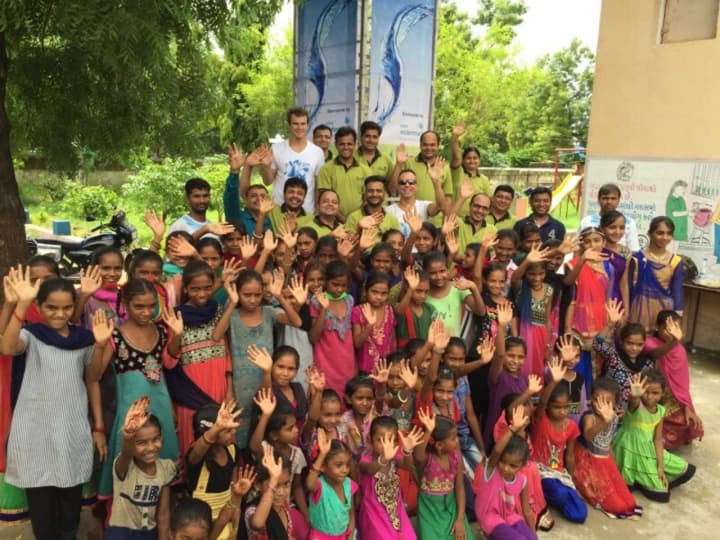 Dylan Kelly, far back row in white shirt, in India.