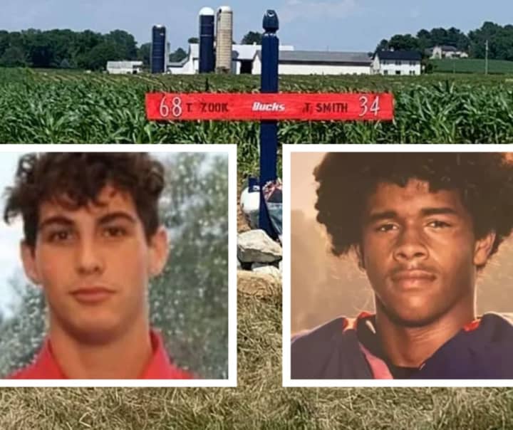 Tyler Zook (left) and Tyreese &#x27;Ty&#x27; Smith (right) in front of the memorial their teammates made for them.