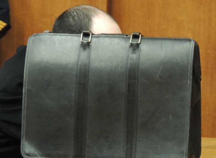 Onn Rapeika remains hidden from a photographer&#x27;s view during court hearing.