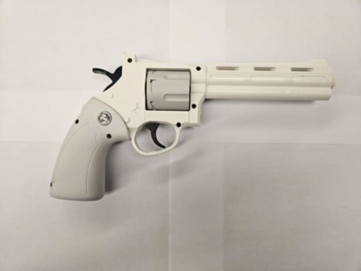 The replica handgun was recovered on school grounds.