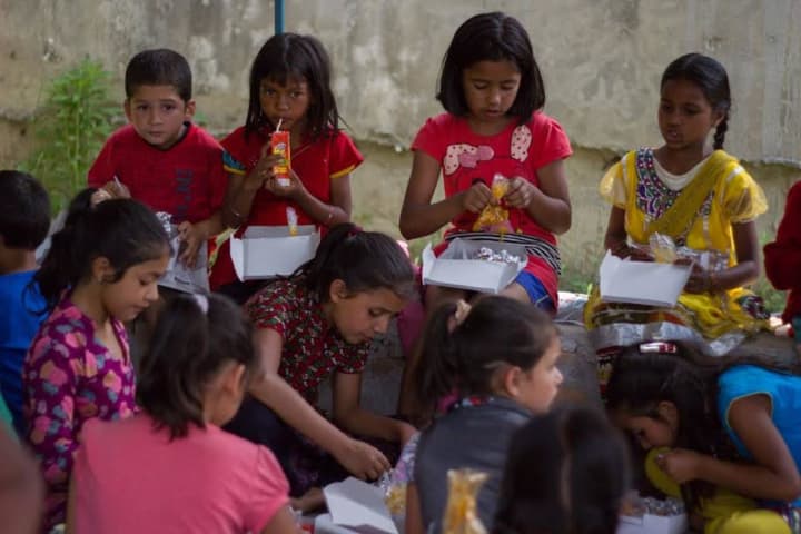 Children eat lunch at earthquake-ravaged Nepal, where Ridgefield Academy chef Ipsa Lama visited over the summer to support relief efforts.
