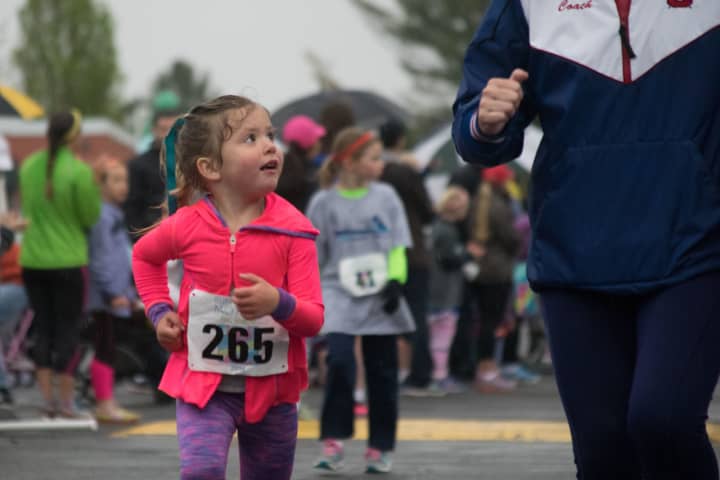 A young girl looks up to her mother in the kids&#x27; race at Sunday&#x27;s Run Like A Mother 5k in Ridgefield.