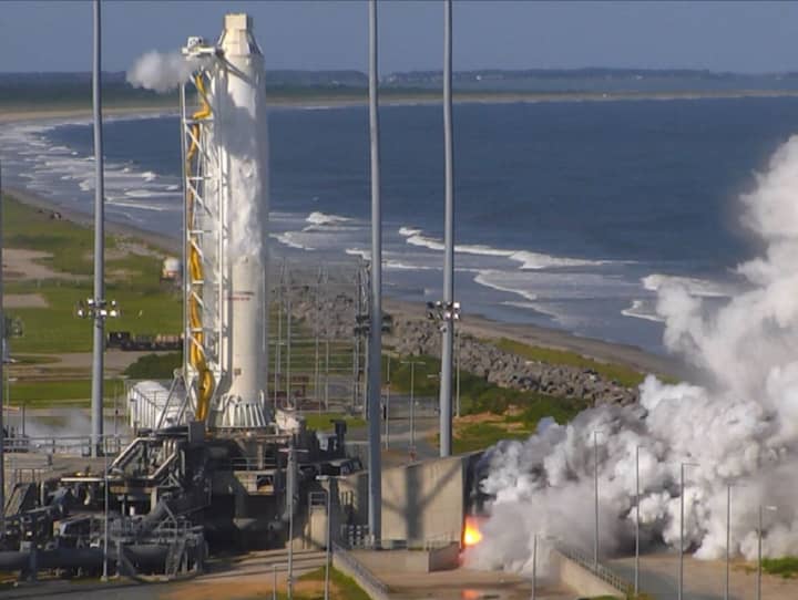 An Orbital ATK Antares rocket first stage fires its RD-181 main engines during a May test at Wallops Island, VA.