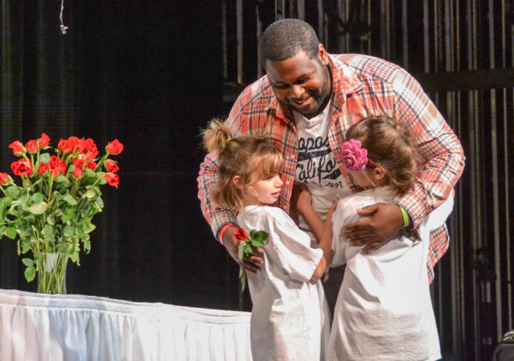 First-grade students from the Winfield Morse School handed out roses to the graduating seniors of Sleepy Hollow High School during a special ceremony.