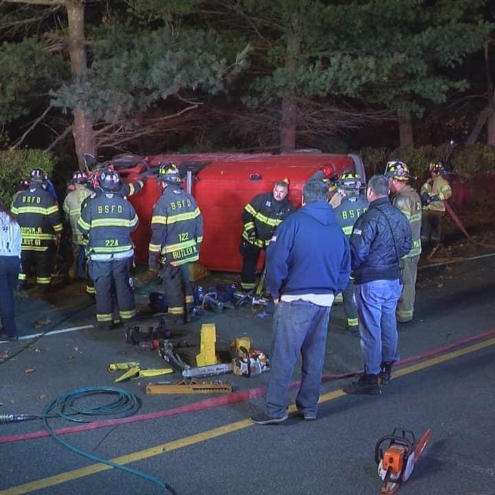 Two people had to be rescued from an overturned van after it slammed into a tree on Long Island.