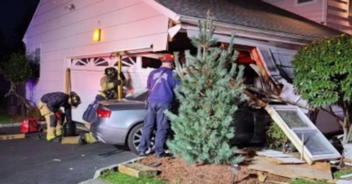 A Stamford home received extensive damage after a vehicle slammed into the garage area.