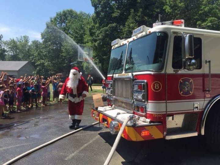 Santa and Engine 8 bring relief to a sizzling afternoon Friday at Boys and Girls Club of Greenwich Camp Simmons.