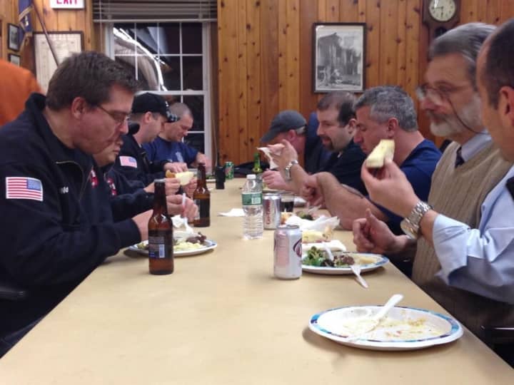 Scarsdale firefighters enjoy a meal at the firehouse. They will share their cooking secrets during the Scarsdale Cookbook Club event on Saturday, Jan. 30, at the library.
