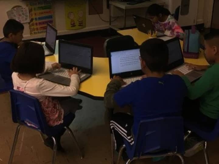 Students at Berkeley Avenue Elementary School in Westwood work on writing essays.