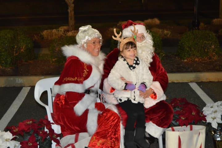 Santa and Mrs. Claus meet with kids at the Stony Hill tree lighting. 