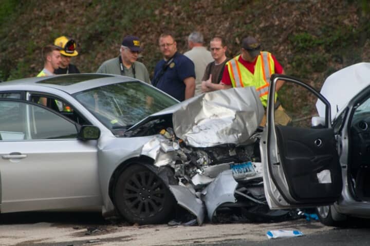 First responders investigate the crash scene at Rive Road and Mt. Pleasant Road in Shelton on Wednesday.