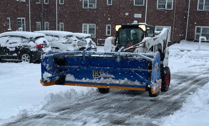 A snowplow clearing a parking lot on Tuesday, Feb. 13.