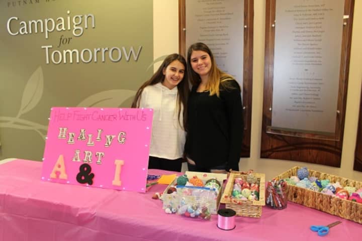 Adelina Ademaj, on left, and Isabella DeChico sell holiday ornaments and pens in the Putnam Hospital Center lobby.