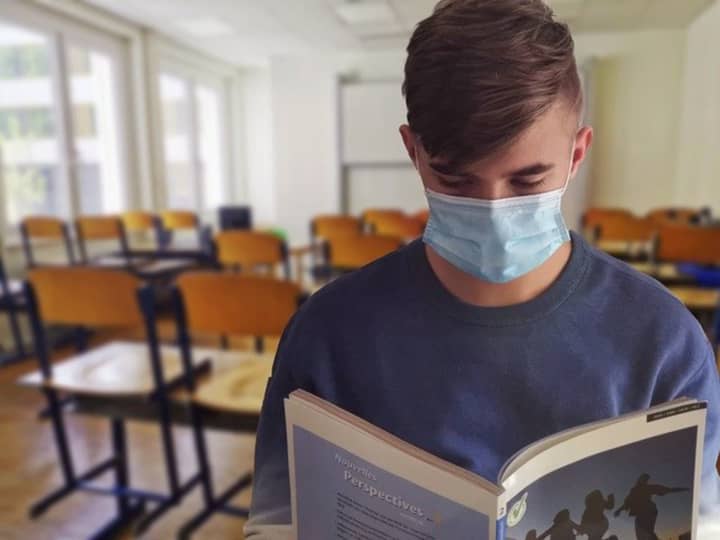 A student wearing a face mask inside a classroom