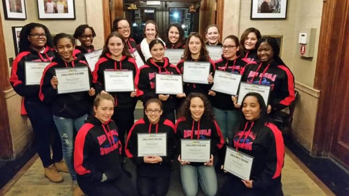 Peekskill&#x27;s Girls Varsity Swim Team holding their Scholar Athlete certificates.