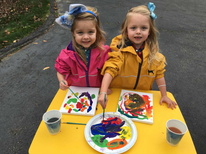 Twins Harper and Sophie create artwork at the Tiny Miracles Foundation&#x27;s World Prematurity Day event.