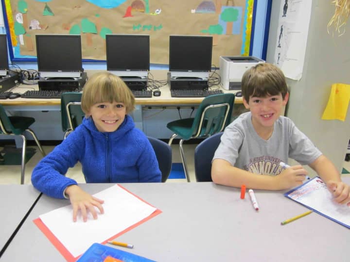 Fourth-graders at the Carrie E. Tompkins Elementary School write letters of thanks to servicemen and women.